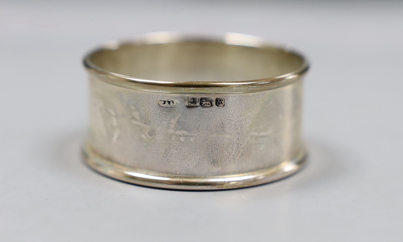 A cased set of six modern silver napkin rings and one other pair of engine turned silver napkin rings.